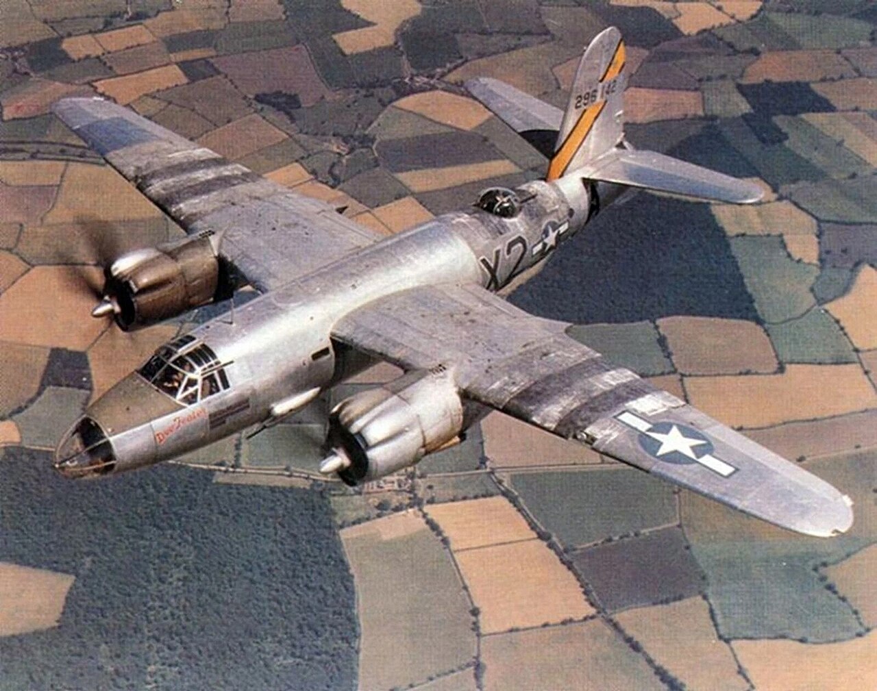 A U.S. Army Air Forces Martin B-26 Marauder flying over fields in Europe.