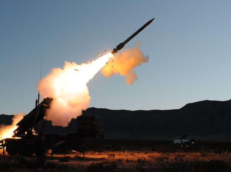 A Patriot PAC-3 missile launching from a ground launcher.