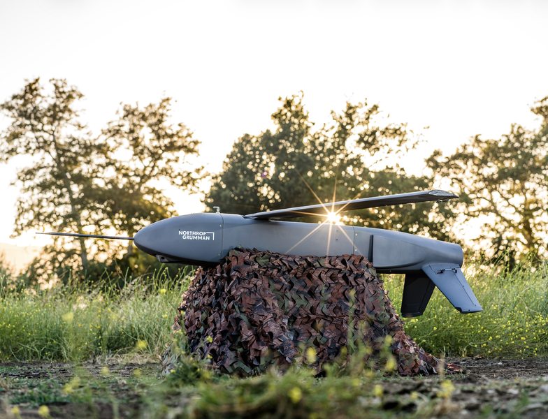 Lumberjack unmanned aircraft resting on camouflage material outdoors.