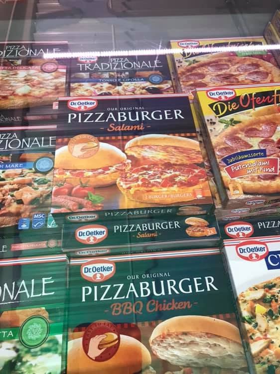 Boxes of Dr. Oetker Pizzaburger among frozen pizzas in a grocery freezer.